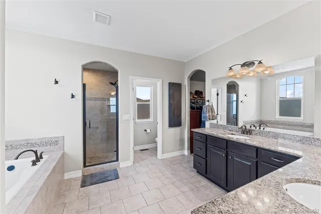 a spacious bathroom with a granite countertop sink and a mirror