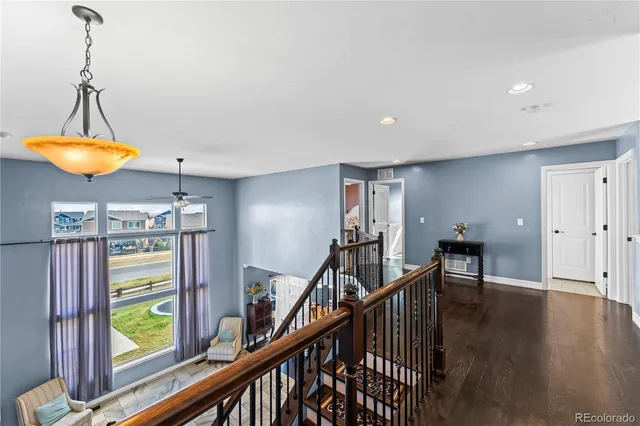 a view of a hallway with furniture and window