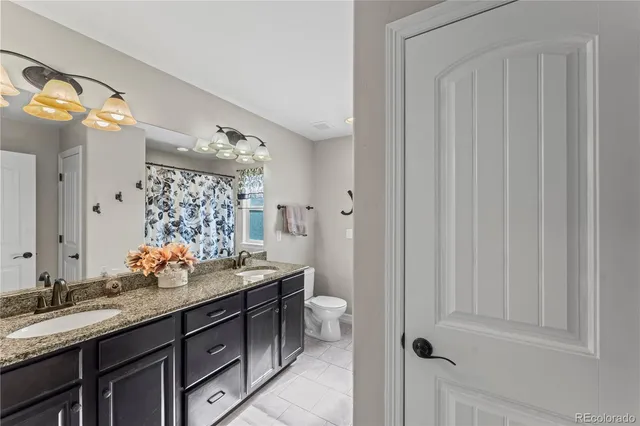 a bathroom with double sink and a mirror