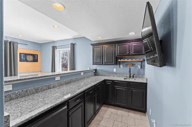 a kitchen with a sink and a wooden cabinets