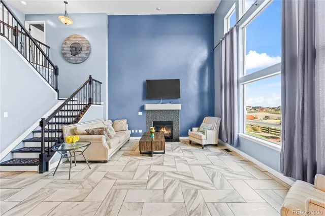 a living room with fireplace furniture and a window