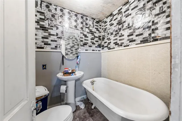 a bathroom with a sink toilet and mirror