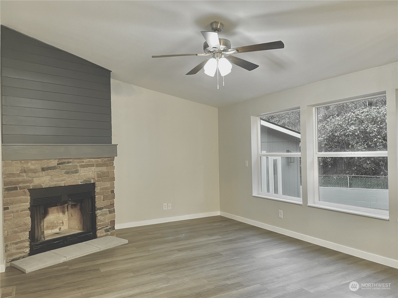 125 Hackett Road Longview, WA 98632 - Photo 12 of 34 a view of an empty room with wooden floor fireplace and a window