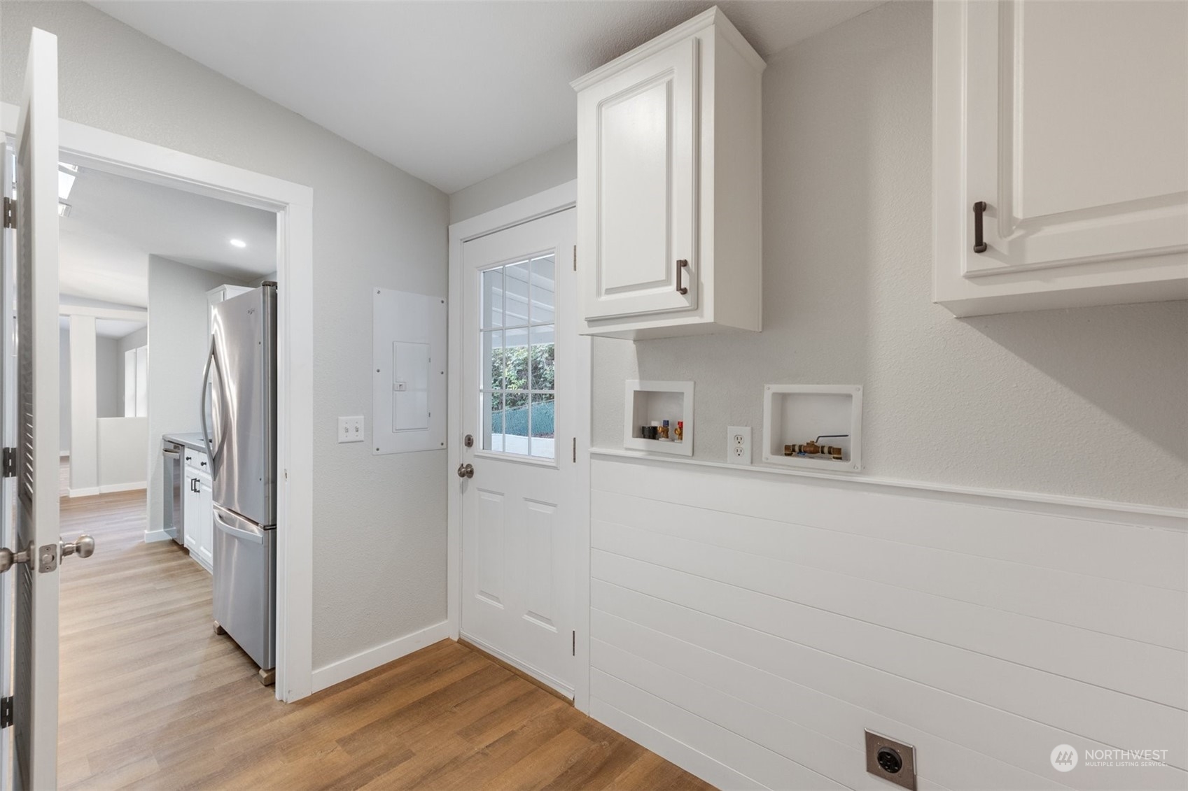 125 Hackett Road Longview, WA 98632 - Photo 18 of 34 a view of a kitchen with white cabinets and wooden floor