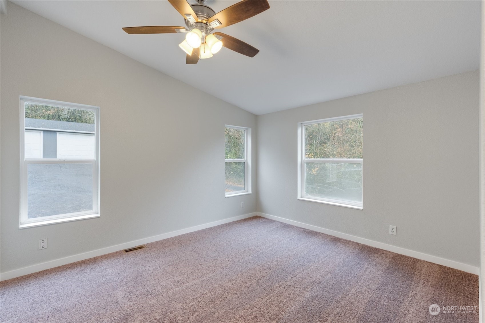 125 Hackett Road Longview, WA 98632 - Photo 19 of 34 an empty room with a window and a fan