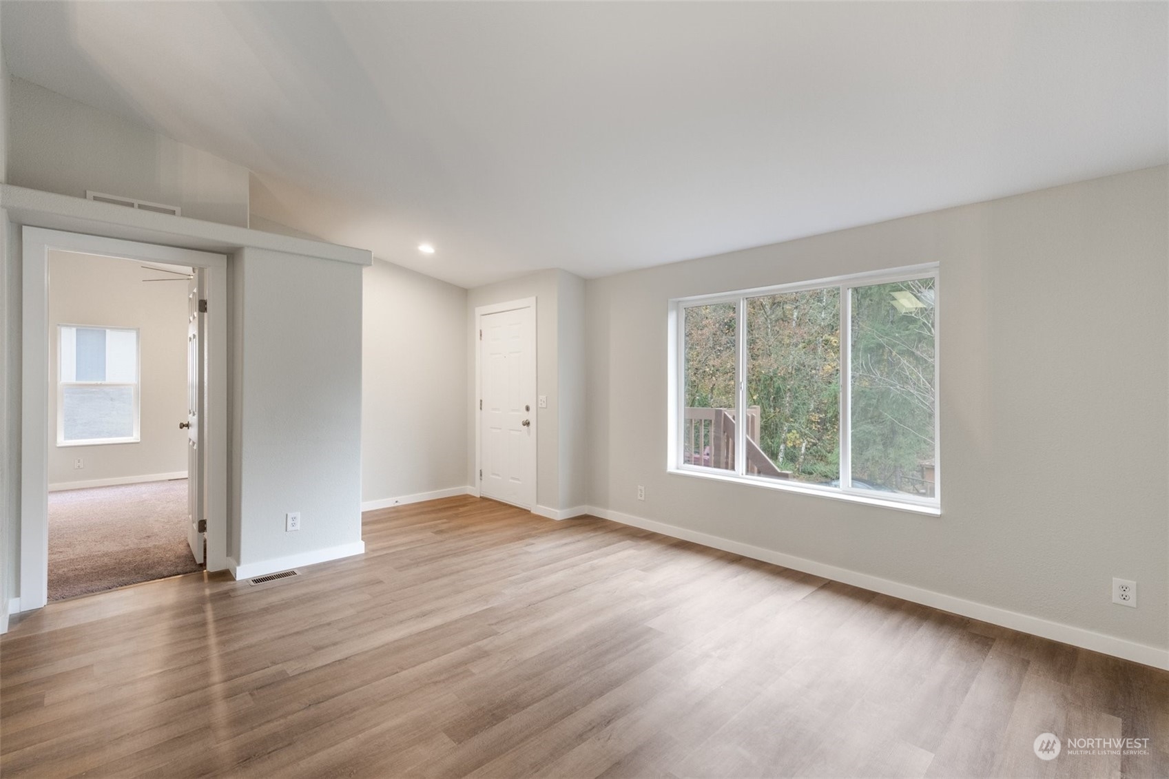 125 Hackett Road Longview, WA 98632 - Photo 4 of 34 an empty room with wooden floor and windows