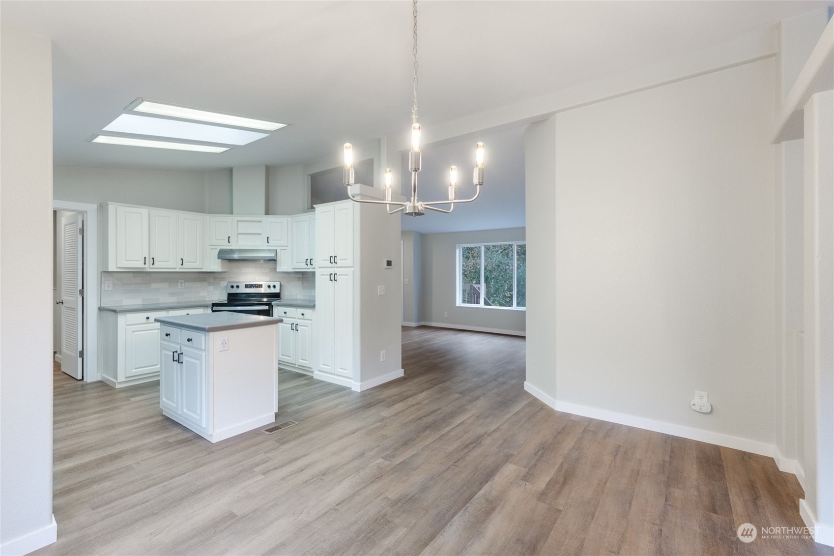 125 Hackett Road Longview, WA 98632 - Photo 6 of 34 a kitchen with a refrigerator and chandelier