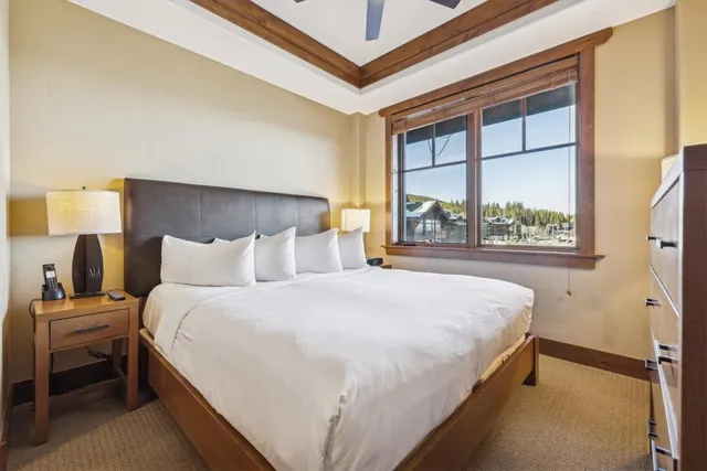 a bedroom with a bed lamp and window