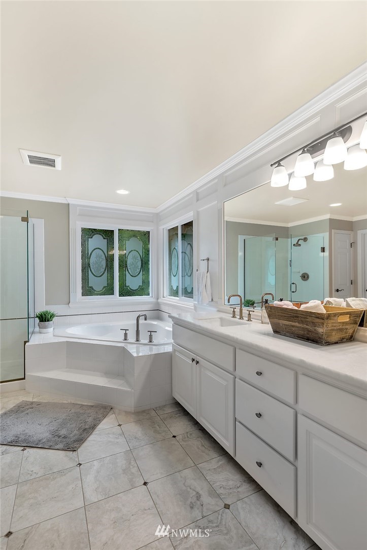 5010 176th Street Southeast Bothell, WA 98012 - Photo 14 of 25 a spacious bathroom with a granite countertop sink mirror and bathtub