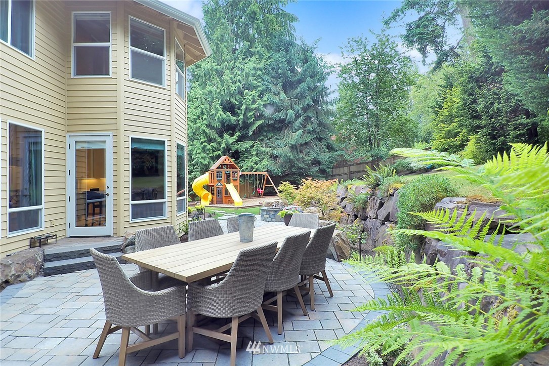 5010 176th Street Southeast Bothell, WA 98012 - Photo 18 of 25 a view of a patio with table and chairs with wooden floor and plants