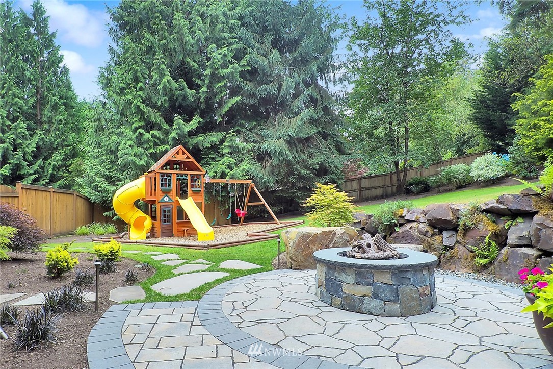 5010 176th Street Southeast Bothell, WA 98012 - Photo 19 of 25 a view of a backyard with plants and chairs