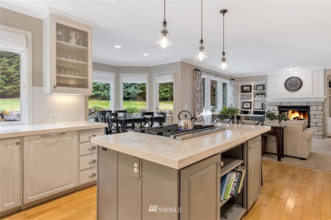 5010 176th Street Southeast Bothell, WA 98012 - Photo 6 of 25 a kitchen with stainless steel appliances granite countertop a sink a stove and a wooden floors
