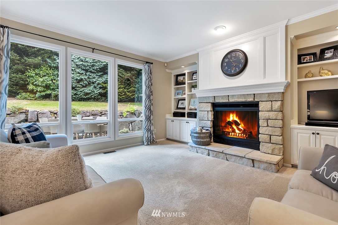 5010 176th Street Southeast Bothell, WA 98012 - Photo 8 of 25 a living room with furniture a large window and a fireplace