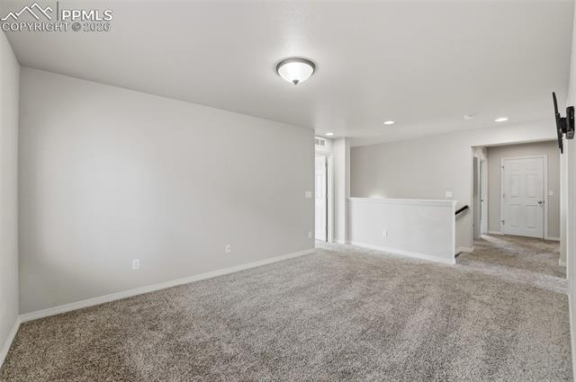 2224 Reed Grass Way Colorado Springs, CO 80915 - Photo 26 of 39 Unfurnished room with carpet flooring and recessed lighting