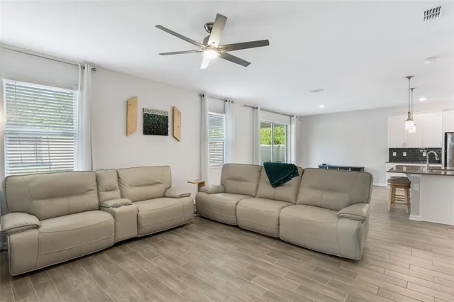 a kitchen with stainless steel appliances granite countertop a sink counter space and a wooden floor