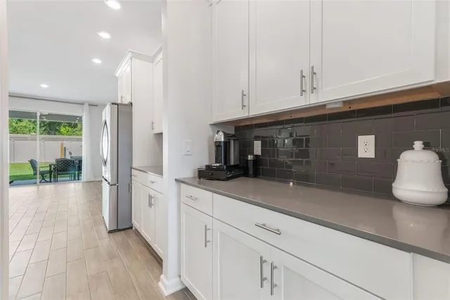 a bathroom with a granite countertop sink a toilet and a mirror