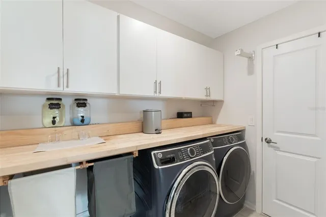 a spacious bathroom with a granite countertop sink and a mirror