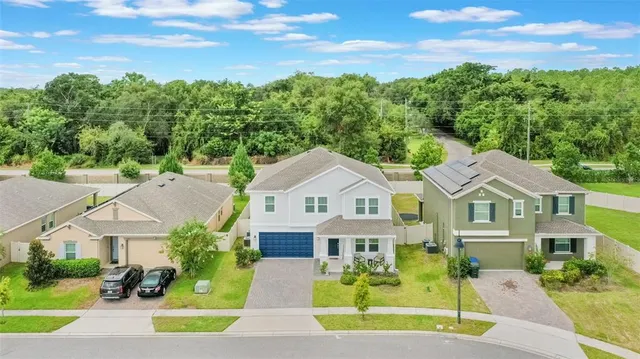 an aerial view of residential house with outdoor space and pool view