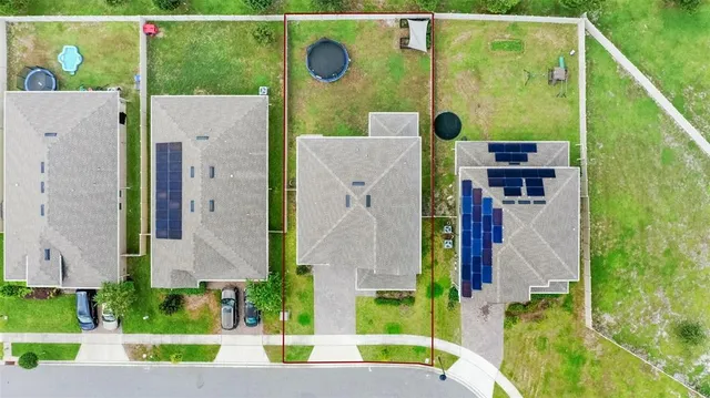 an aerial view of residential houses with outdoor space