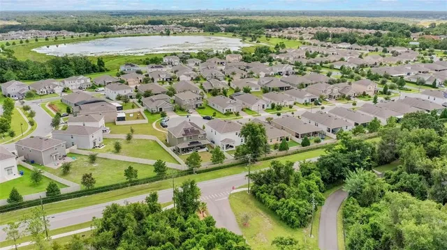 an aerial view of residential houses with outdoor space