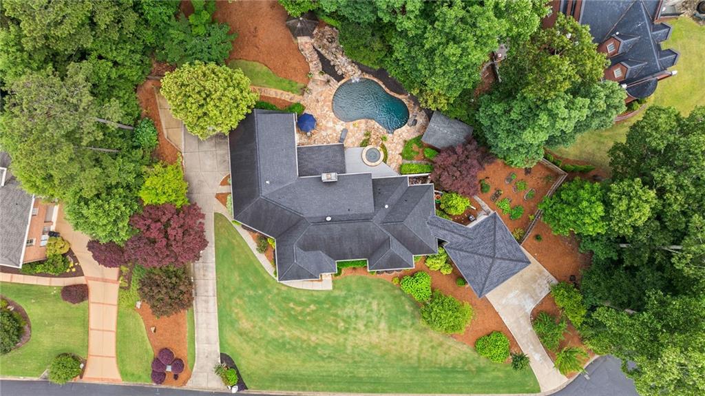 an aerial view of a house with a yard