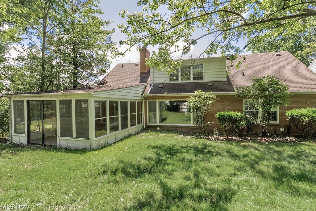 23655 Wimbledon Road Shaker Heights, OH 44122 - Photo 23 of 23 Back of house with a sunroom and a yard