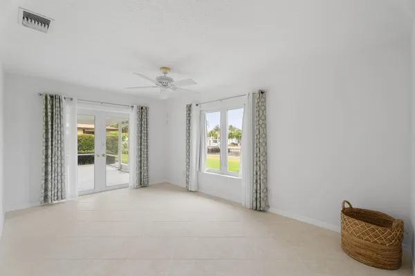 an empty room with windows and closet