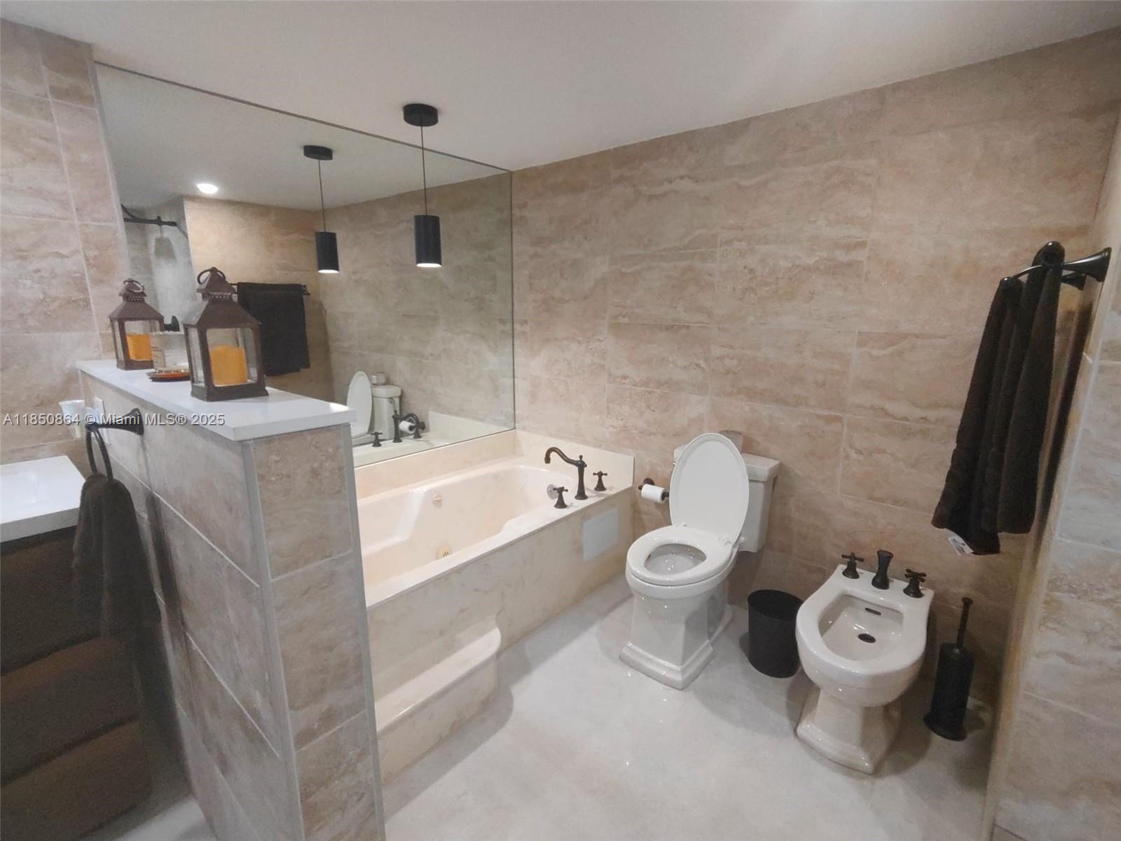 520 Brickell Key Drive, Unit A1102 Miami, FL 33131 - Photo 22 of 33 a bathroom with a toilet sink and mirror