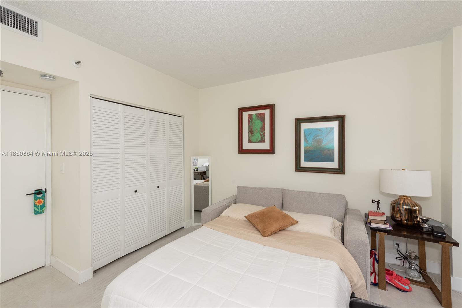 520 Brickell Key Drive, Unit A1102 Miami, FL 33131 - Photo 23 of 33 a bedroom with a bed and a closet