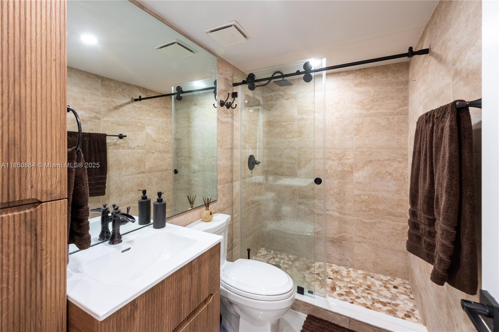 520 Brickell Key Drive, Unit A1102 Miami, FL 33131 - Photo 25 of 33 a bathroom with a sink toilet and shower