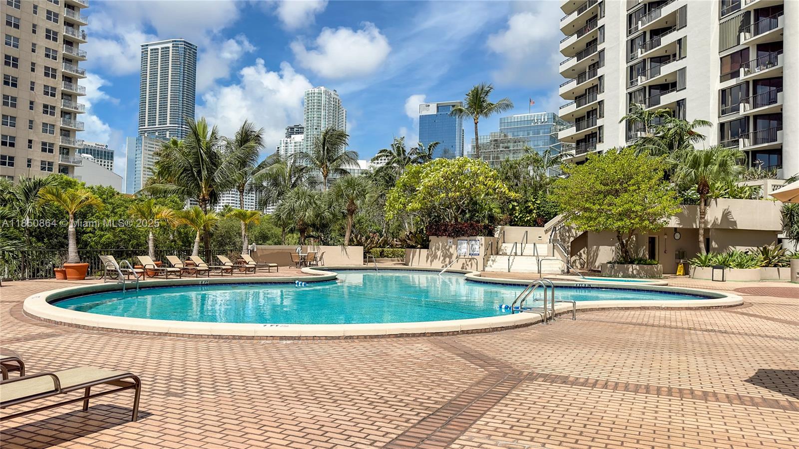520 Brickell Key Drive, Unit A1102 Miami, FL 33131 - Photo 28 of 33 a view of a swimming pool with a lounge chairs