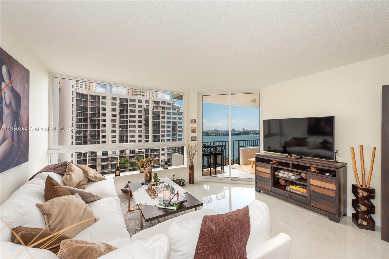 520 Brickell Key Drive, Unit A1102 Miami, FL 33131 - Photo 3 of 33 a living room with furniture and a flat screen tv