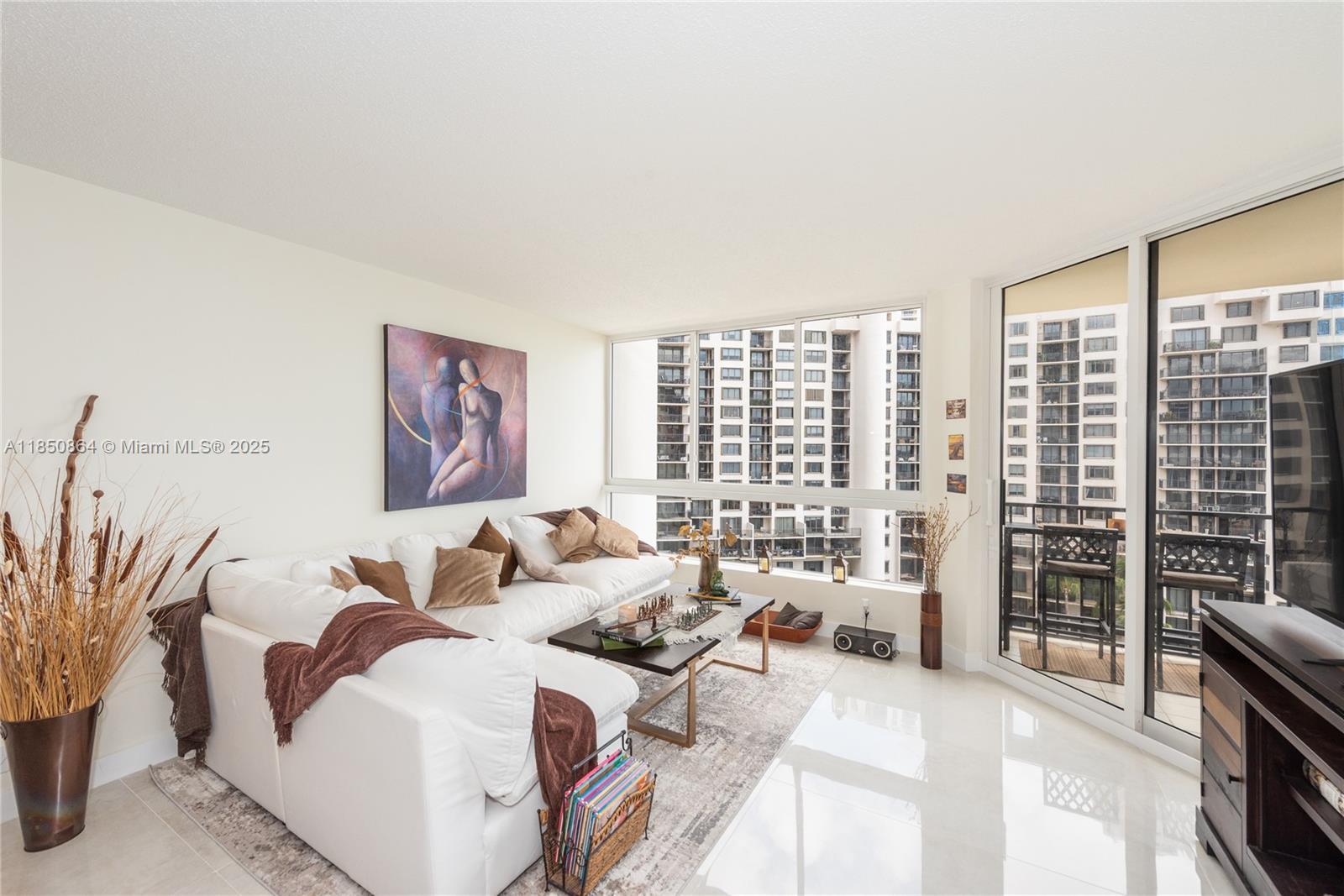 520 Brickell Key Drive, Unit A1102 Miami, FL 33131 - Photo 6 of 33 a living room with furniture and large windows