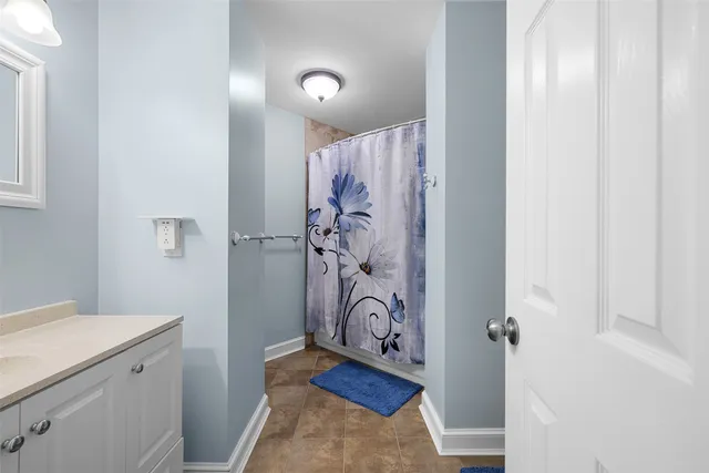 a bathroom with a shower and a sink