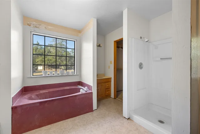 a bath room with a bath tub and a shower