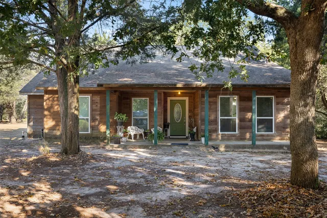 a front view of a house with yard porch and outdoor seating