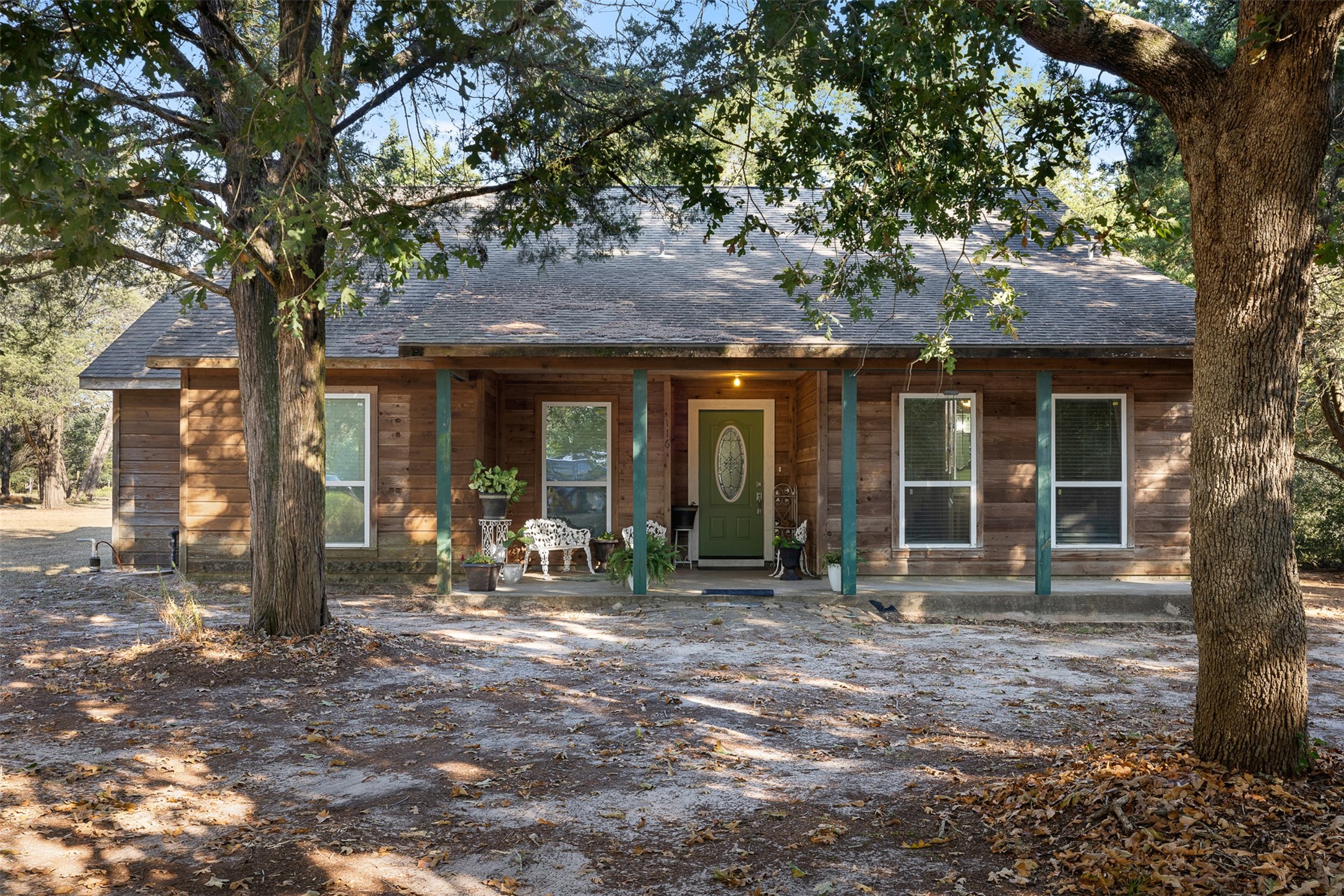 116 Lost Lane Bellville, TX 77418 - Photo 3 of 32 a front view of a house with yard porch and outdoor seating