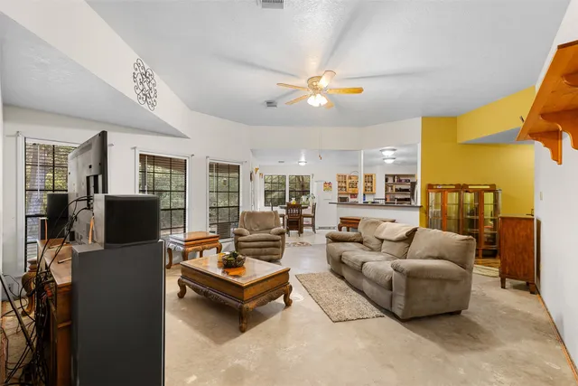 a living room with furniture ceiling fan and a rug