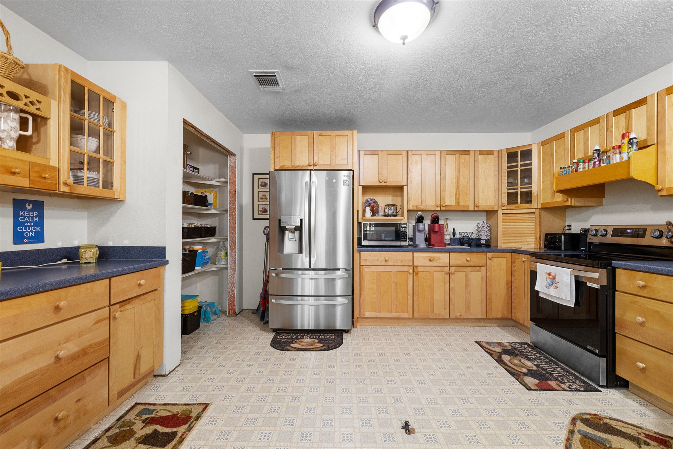 116 Lost Lane Bellville, TX 77418 - Photo 10 of 32 a kitchen with refrigerator and cabinets