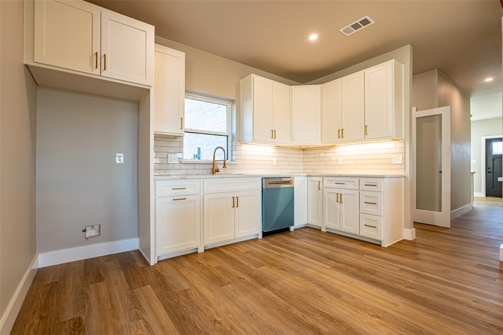 2128 Eagles Rdg Drive Weatherford, TX 76087 - Photo 30 of 39 Kitchen with white cabinetry, light wood-style floors, and decorative backsplash