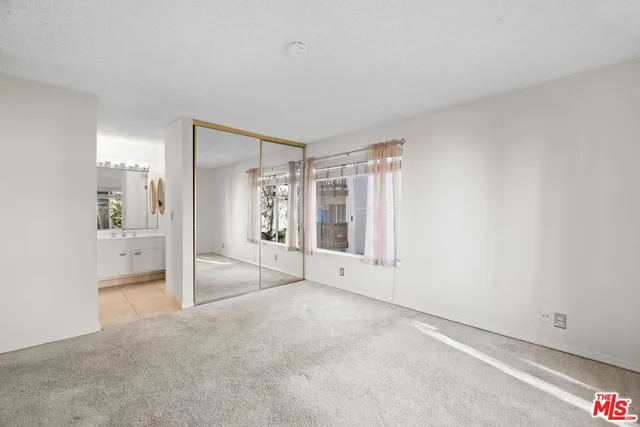 a view of an empty room and a window