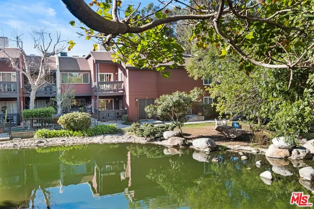 a large body of water with a building in the background