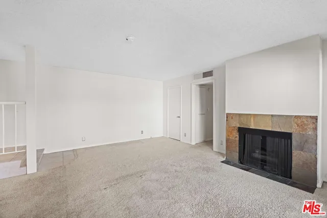 an empty room with a fireplace
