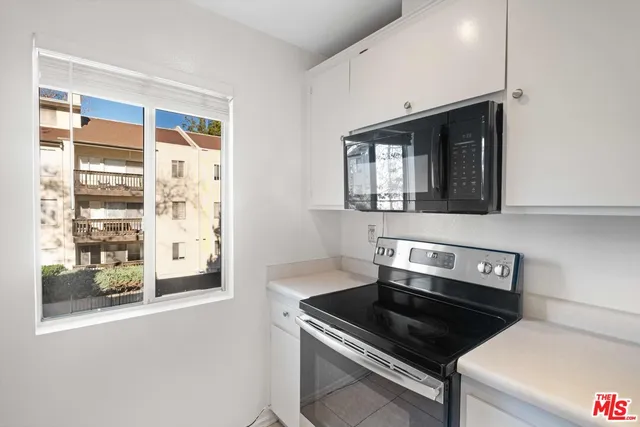 a kitchen with a stove and a microwave