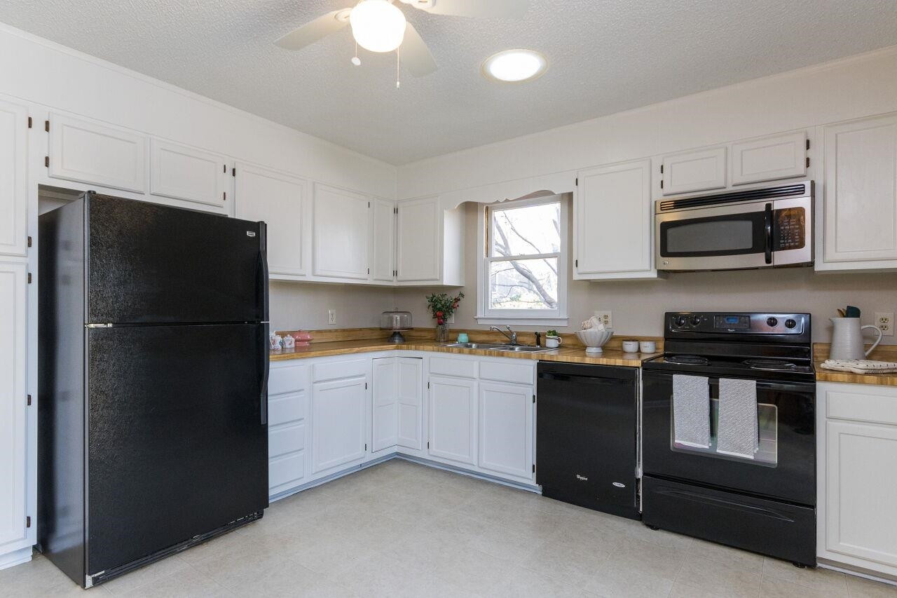 718 Red Forest Trail Raleigh, NC 27615 - Photo 10 of 30 Kitchen is located in the back of the home overlooking the private yard with large patio. Bright White Kitchen