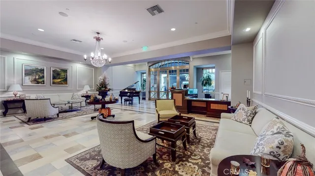 a living room with lots of furniture and view of kitchen