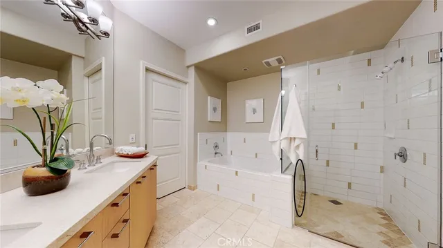 a bathroom with a tub sink and mirror