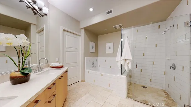 a bathroom with a tub sink and mirror