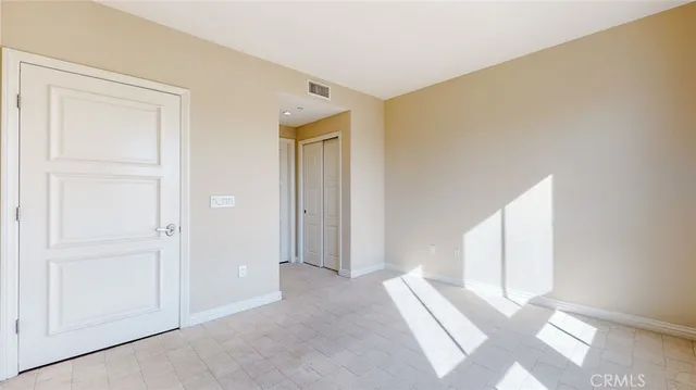 a view of a room with an empty space and wooden floor