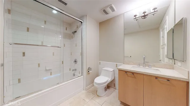 a bath room with a toilet a sink and a bath tub